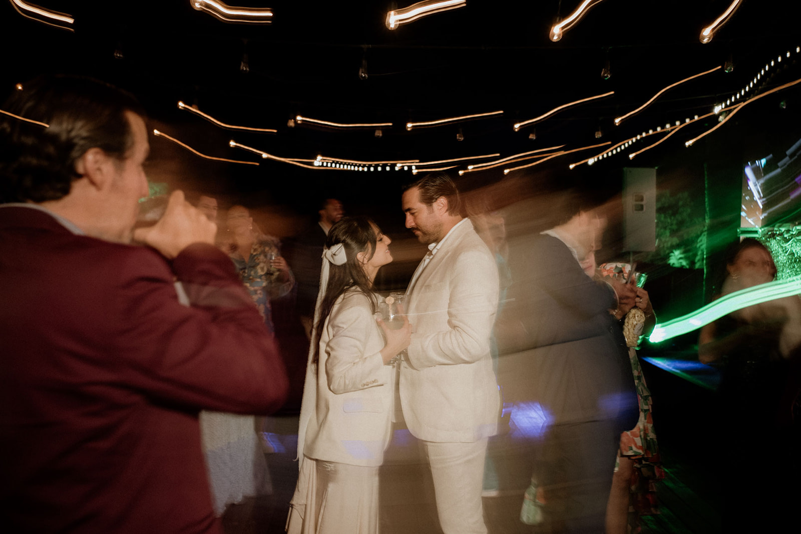 Bride and groom dancing under lights